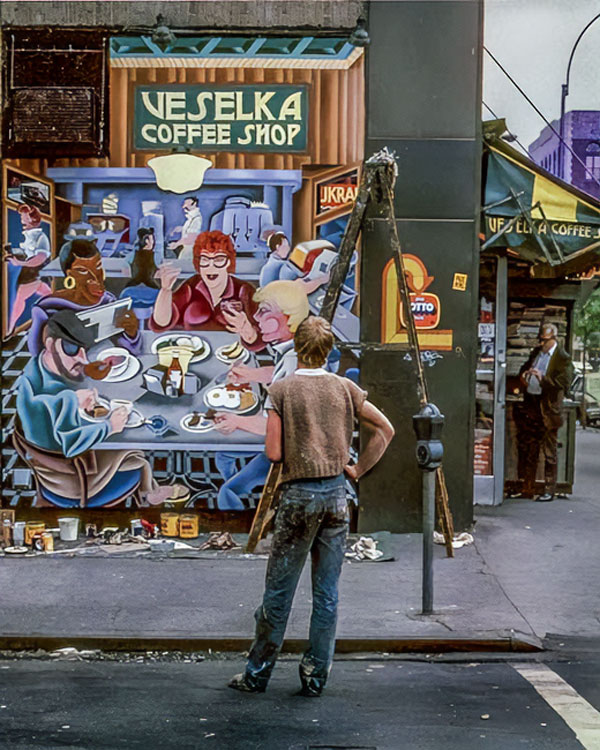 Charnick at work on an exterior mural